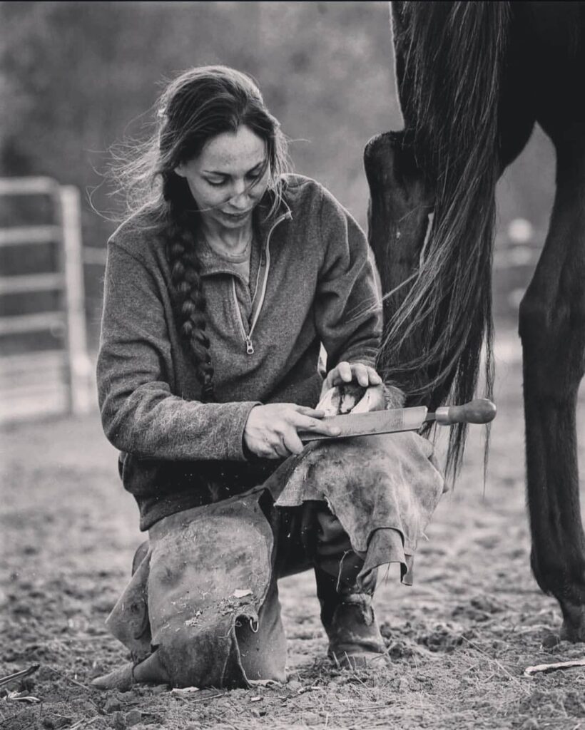 Kristen Moore doing farrier work on horse